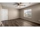 Bedroom with wood-look floors, neutral colored walls, and a window overlooking the neighborhood at 22322 W Loma Linda Cir, Buckeye, AZ 85326