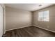 Bedroom with wood-look floors, a window overlooking the neighborhood, and neutral walls at 22322 W Loma Linda Cir, Buckeye, AZ 85326
