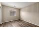 Cozy bedroom with neutral paint, wood-look floors, and a bright window at 22322 W Loma Linda Cir, Buckeye, AZ 85326