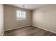 Bedroom with wood-look floors, a window overlooking the street, and neutral colored walls at 22322 W Loma Linda Cir, Buckeye, AZ 85326