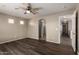 Bedroom featuring wood-look floors, neutral walls, ceiling fan and archway entrance at 22322 W Loma Linda Cir, Buckeye, AZ 85326
