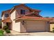 Beige two-story home with red tile roof, green grass, and desert landscaping at 22322 W Loma Linda Cir, Buckeye, AZ 85326