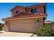 Home exterior showcasing a two-car garage, complemented by a red-tiled roof and low landscape at 22322 W Loma Linda Cir, Buckeye, AZ 85326