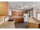 Spacious kitchen with wood cabinetry, sleek countertops, and modern white appliances at 22322 W Loma Linda Cir, Buckeye, AZ 85326