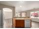 Open kitchen design with wood cabinets, modern appliances, and easy access to living area at 22322 W Loma Linda Cir, Buckeye, AZ 85326