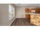 Cozy kitchen featuring wood cabinets, tile backsplash, and bar seating at 22322 W Loma Linda Cir, Buckeye, AZ 85326