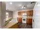 Well-lit kitchen featuring wood cabinets, white appliances, and a convenient breakfast bar at 22322 W Loma Linda Cir, Buckeye, AZ 85326