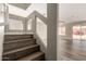Stylish staircase with wooden steps and glass panel, leading to open living space at 22322 W Loma Linda Cir, Buckeye, AZ 85326