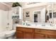 Well-maintained bathroom boasts a wood vanity and large mirror at 22543 W Cocopah St, Buckeye, AZ 85326