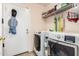 Spacious laundry room includes washer, dryer, and overhead storage at 22543 W Cocopah St, Buckeye, AZ 85326