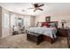 Main bedroom features neutral walls, shutters, ceiling fan, and carpet flooring at 22543 W Cocopah St, Buckeye, AZ 85326