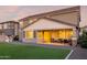 Spacious backyard with manicured synthetic grass, patio, and playhouse enhancing the outdoor living experience of the home at 23042 E Excelsior Ave, Queen Creek, AZ 85142