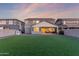 A vast backyard features synthetic grass, a charming playhouse and is perfect for a Gathering-friendly outdoor lifestyle at 23042 E Excelsior Ave, Queen Creek, AZ 85142