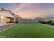 Expansive backyard featuring lush green turf and gravel, offering a low-maintenance outdoor space perfect for recreation at 23042 E Excelsior Ave, Queen Creek, AZ 85142