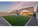Spacious backyard featuring lush green turf, a patio area, and playhouse, offering endless possibilities for outdoor enjoyment at 23042 E Excelsior Ave, Queen Creek, AZ 85142