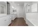 Primary bathroom with dual sinks, a walk-in shower, and a soaking tub offers a luxurious retreat at 23042 E Excelsior Ave, Queen Creek, AZ 85142