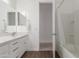 Bathroom featuring a white vanity, mirror, and shower/tub combination at 23042 E Excelsior Ave, Queen Creek, AZ 85142