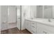 Bathroom with a white double vanity, framed mirrors, and a view into the bedroom at 23042 E Excelsior Ave, Queen Creek, AZ 85142