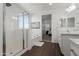 Bright bathroom with glass-enclosed shower, soaking tub, and double vanity offers a spa-like experience at 23042 E Excelsior Ave, Queen Creek, AZ 85142