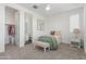 Well-lit bedroom featuring a comfortable twin bed, ceiling fan, and neutral carpet at 23042 E Excelsior Ave, Queen Creek, AZ 85142