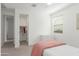 Bright bedroom featuring neutral carpet, a walk-in closet, and natural light from the window at 23042 E Excelsior Ave, Queen Creek, AZ 85142