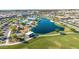 Aerial view of community lake, playground, swimming pool and clubhouse providing residents with picturesque recreational amenities at 23042 E Excelsior Ave, Queen Creek, AZ 85142