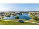 Picturesque aerial showcases a lake, playground, swimming pool and clubhouse enhancing the appeal of this Gathering-friendly community at 23042 E Excelsior Ave, Queen Creek, AZ 85142