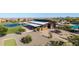 Aerial view of community pool and clubhouse near a scenic lake and lush landscaping at 23042 E Excelsior Ave, Queen Creek, AZ 85142
