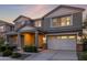 Exterior home showcasing architectural details, including a two-car garage and inviting front entrance at 23042 E Excelsior Ave, Queen Creek, AZ 85142
