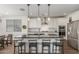 Modern kitchen featuring a center island with bar seating, stainless steel appliances, and pendant lighting at 23042 E Excelsior Ave, Queen Creek, AZ 85142