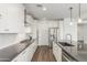Modern kitchen features white cabinets, stainless steel appliances, dark countertops, and hardwood floors at 23042 E Excelsior Ave, Queen Creek, AZ 85142