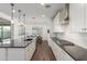 Bright kitchen with white cabinetry, stainless steel appliances, and dark countertops offers a modern, inviting space at 23042 E Excelsior Ave, Queen Creek, AZ 85142