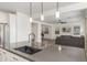 Open-concept kitchen with island, pendant lighting, and stainless steel appliances flows into the living area at 23042 E Excelsior Ave, Queen Creek, AZ 85142