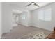 Open living area with carpet flooring, and natural light coming through the windows, and access to the hallway at 23042 E Excelsior Ave, Queen Creek, AZ 85142