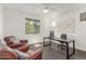 Bright office boasts a ceiling fan, natural light, and two leather chairs with a desk at 23042 E Excelsior Ave, Queen Creek, AZ 85142