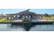 Modern outdoor lounge with covered seating overlooking the peaceful lake at 23042 E Excelsior Ave, Queen Creek, AZ 85142