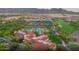 Aerial view showcases community amenities like a clubhouse, pool, tennis courts, and a golf course at 26484 W Mohawk Ln, Buckeye, AZ 85396