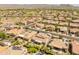 Aerial view of a residential community with well-maintained homes, streets, and desert landscape at 26484 W Mohawk Ln, Buckeye, AZ 85396