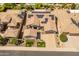 Aerial view of the home with solar panels, a lush green yard and neighborhood at 26484 W Mohawk Ln, Buckeye, AZ 85396