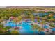 Aerial view highlighting the community's resort-style pool area with palm trees and ample seating at 26484 W Mohawk Ln, Buckeye, AZ 85396