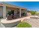 Beautiful backyard featuring a covered patio, manicured landscaping, and desert rock at 26484 W Mohawk Ln, Buckeye, AZ 85396