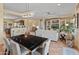 Bright dining area with a modern chandelier, marble table, and view of the cozy living room at 26484 W Mohawk Ln, Buckeye, AZ 85396