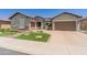 Charming home featuring desert landscaping, artificial turf, and a two-car garage at 26484 W Mohawk Ln, Buckeye, AZ 85396
