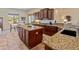 Kitchen with dark cabinets, granite countertops, and a center island at 26484 W Mohawk Ln, Buckeye, AZ 85396