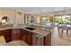 Open-concept kitchen features granite countertops, stainless steel appliances, and a breakfast bar with seating at 26484 W Mohawk Ln, Buckeye, AZ 85396