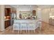 Kitchen featuring tile floors, stainless steel appliances, and breakfast bar seating at 26484 W Mohawk Ln, Buckeye, AZ 85396