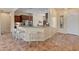 Spacious kitchen featuring tile floors and a breakfast bar with seating at 26484 W Mohawk Ln, Buckeye, AZ 85396