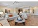 Inviting living room featuring neutral tones, tile floors, and seamless flow to the dining and kitchen areas at 26484 W Mohawk Ln, Buckeye, AZ 85396