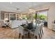 Open-concept living and dining area featuring a built-in entertainment center and backyard views at 26484 W Mohawk Ln, Buckeye, AZ 85396