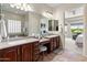 Main bathroom featuring double sinks, vanity, and a view of the soaking tub and bedroom at 26484 W Mohawk Ln, Buckeye, AZ 85396